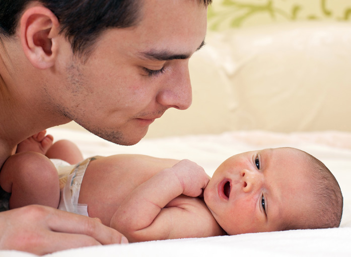 Fathers Day_5_Shutterstock_Father looking at newborn